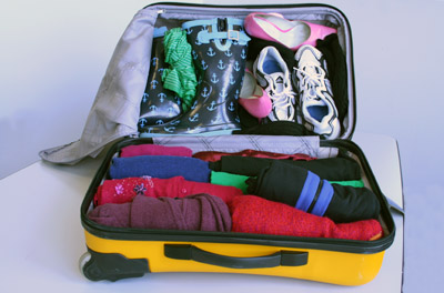 Suitcase With Rolled Clothes And Shoes