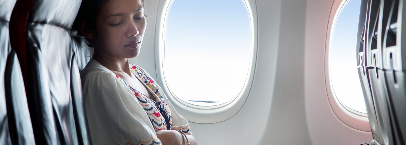woman sleeping on plane