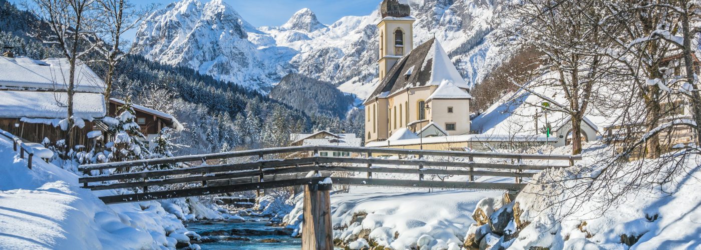 Panoramic view of scenic winter landscape in the Bavarian Alps with famous Parish Church of St. Sebastian in the village of Ramsau, Nationalpark Berchtesgadener Land, Upper Bavaria, Germany