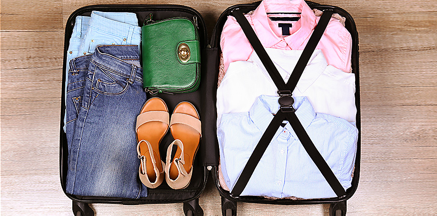Open suitcase fully packed with folded women's clothing