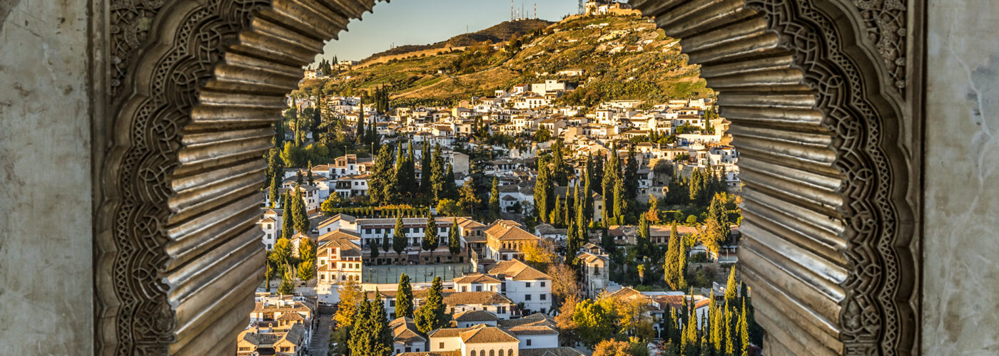 View of the Albayzin district of Granada, Spain, from a window in the Alhambra palace near sunset.