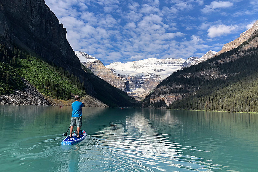 man paddles on lake louise in canada