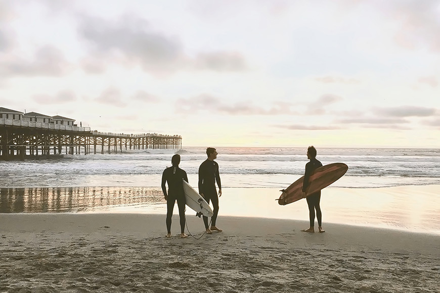 three men surfing in san diego california