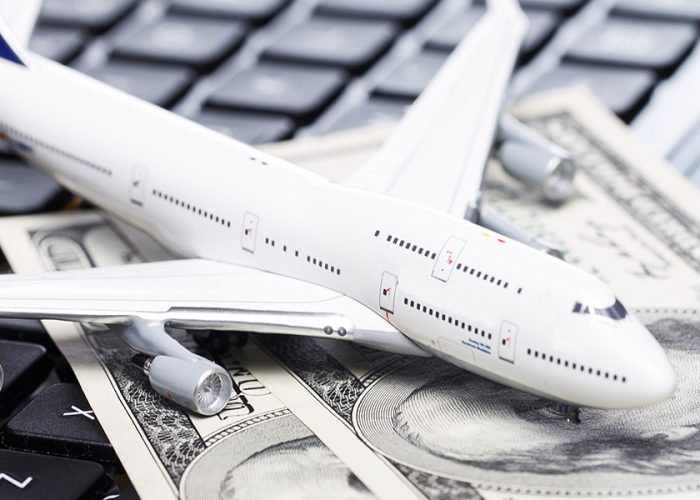 Airplane and Cash on Keyboard Airline Fees