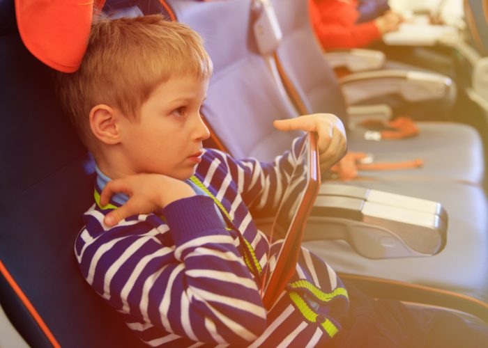 child on plane for airline family seating.