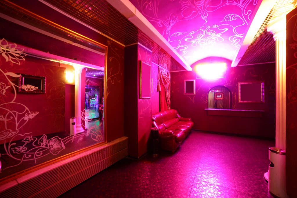 Pink illuminated nightclub hallway