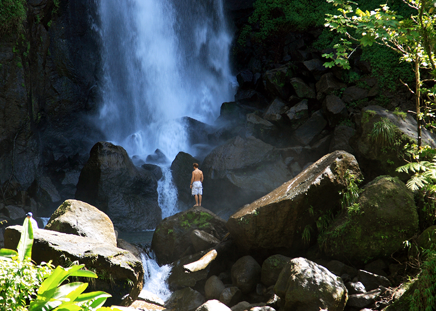 dominica waterfall and hiker