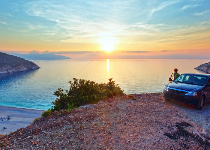 car overlooking greek sunset