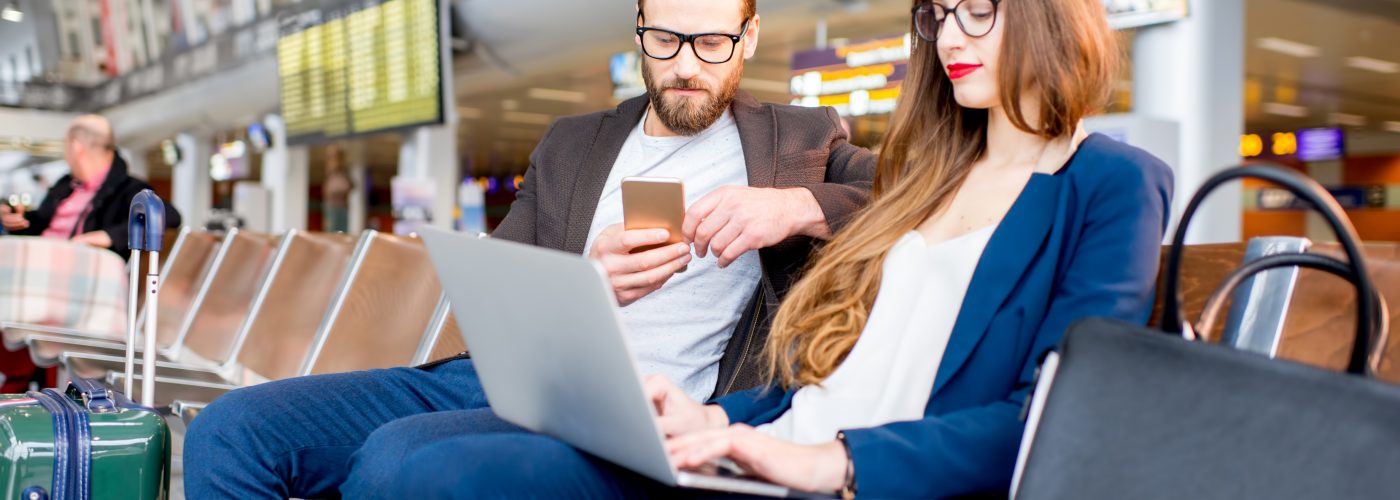 Couple using Wi-Fi at airport