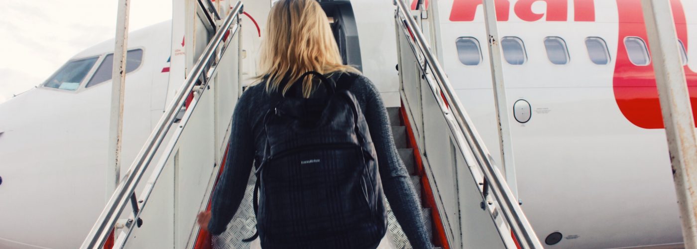 woman boarding plane wearing backpack