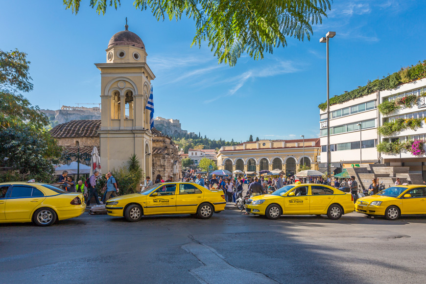 View of Greek Orthodox Church in Monastiraki Square and line of yellow cabs