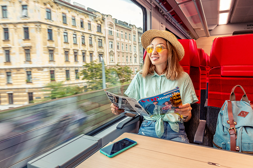 traveling passenger girl reading magazine in QBB train in Vienna