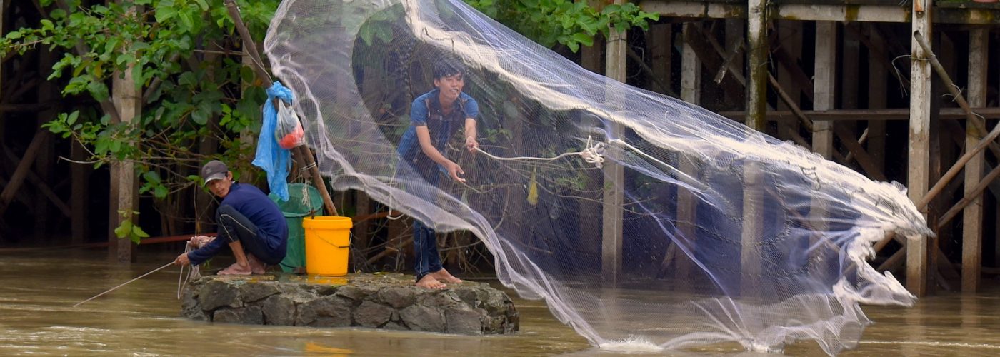 fisherman in vietnam casts his net