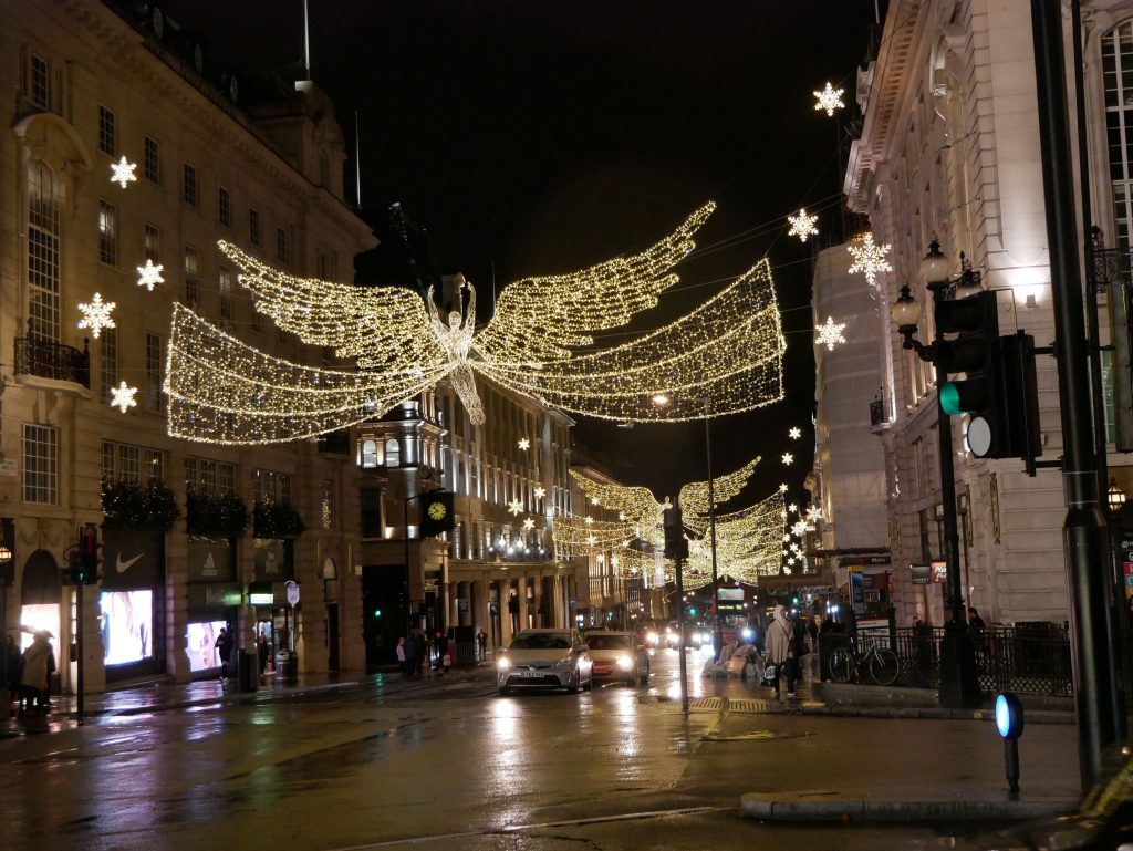 busy street in london with holiday lights