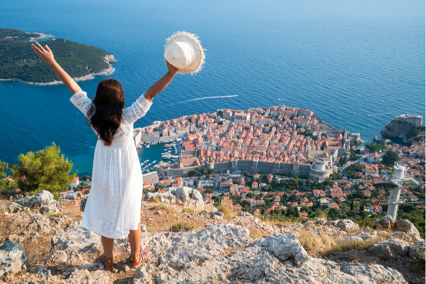 woman standing above dubrovnik.