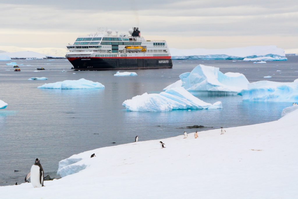 Cruise ship in antarctica with penguins