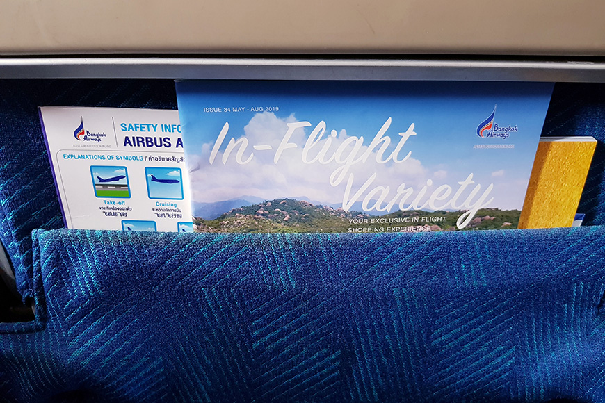 nflight magazine and safety information puts in pocket front of passenger seat