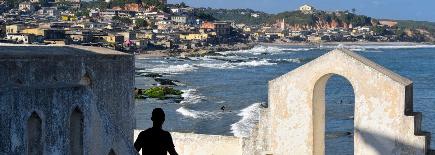 Man looking over coast in Ghana on an ancestry trip