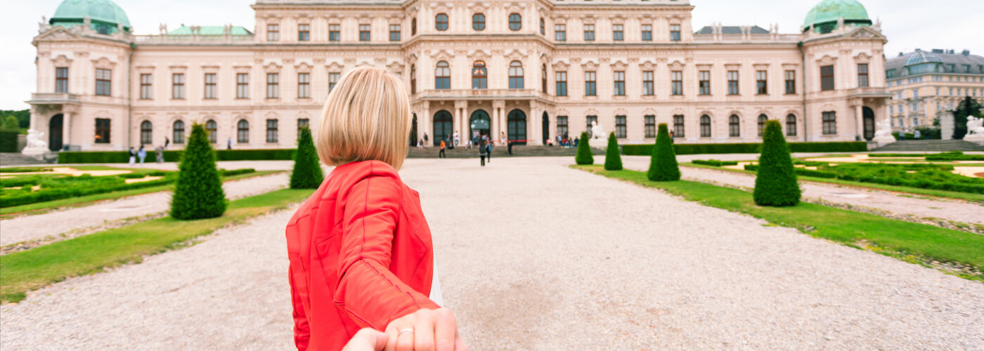 young woman pulling hand belvedere vienna austria.
