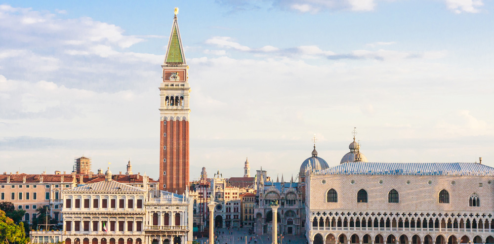 the red-bricked campanile tower rises over the skyline of venice