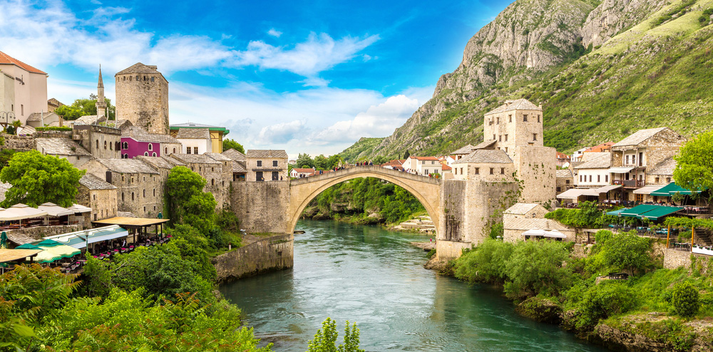 a view of mostar, a city in bosnia overlooking the stari most bridge that flies high above river