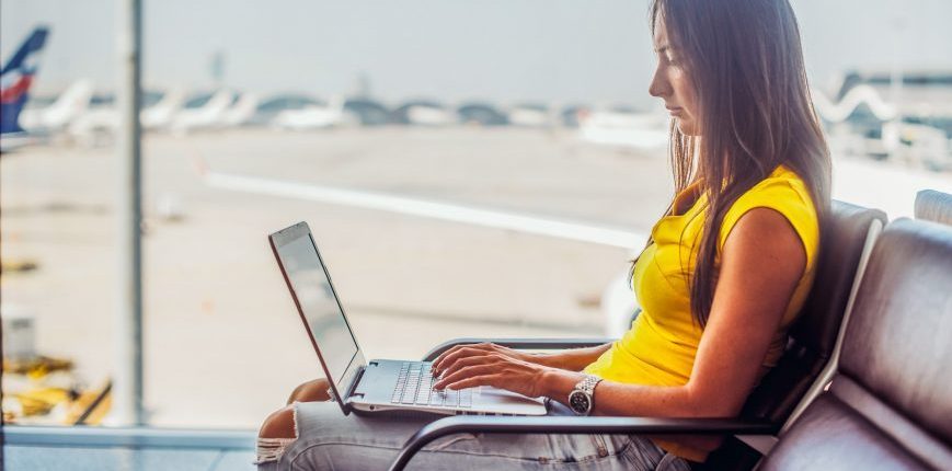 woman using laptop airport wifi