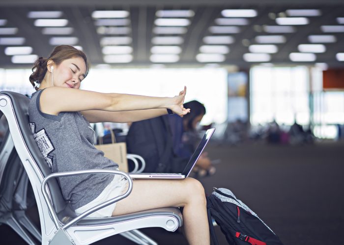 woman stretching in airport