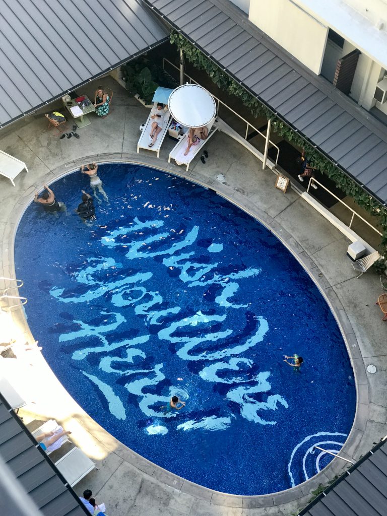 aerial view of a pool with graffiti art at the bottom.