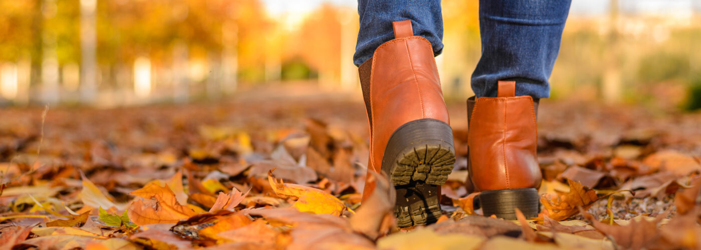 brown boots walking in fall leaves.