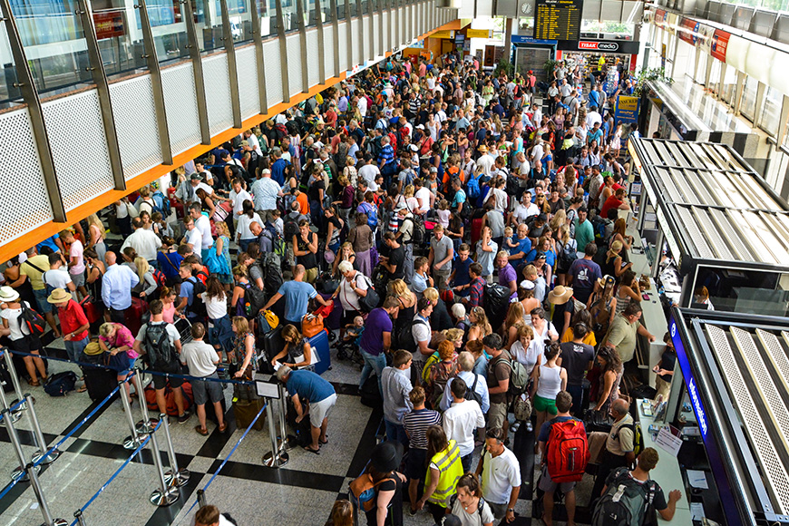 crowd of passengers in the departure hall airport
