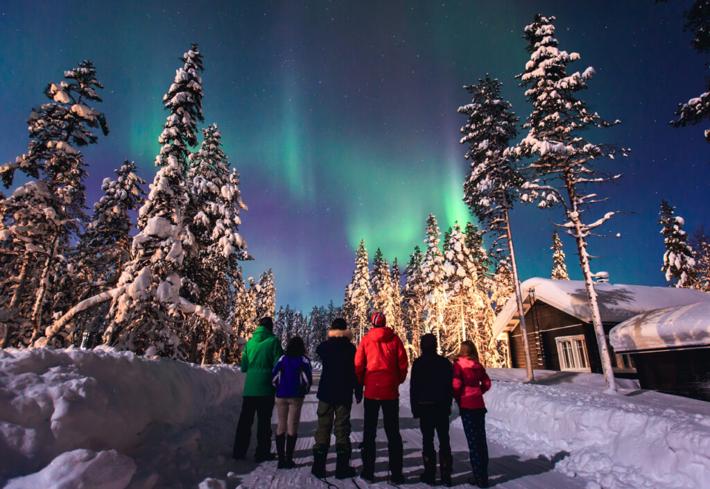 group of people viewing the northern lights in norway