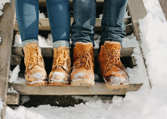 winter boots couple on snowy steps.
