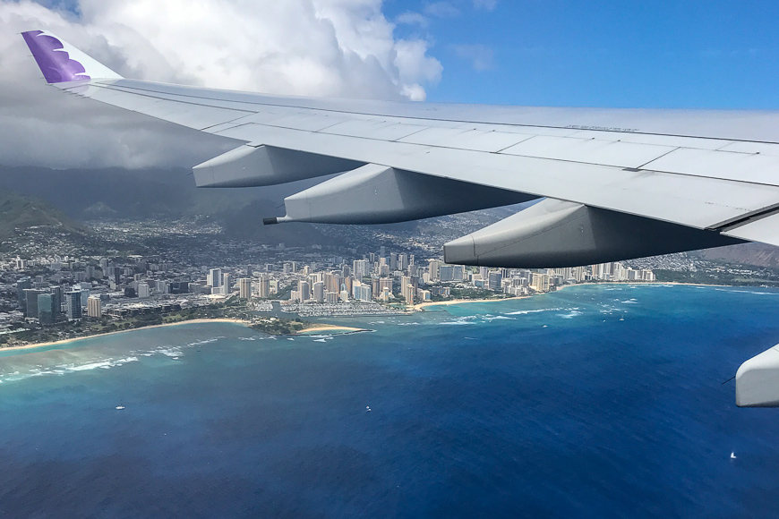 plane flying over city in hawaii