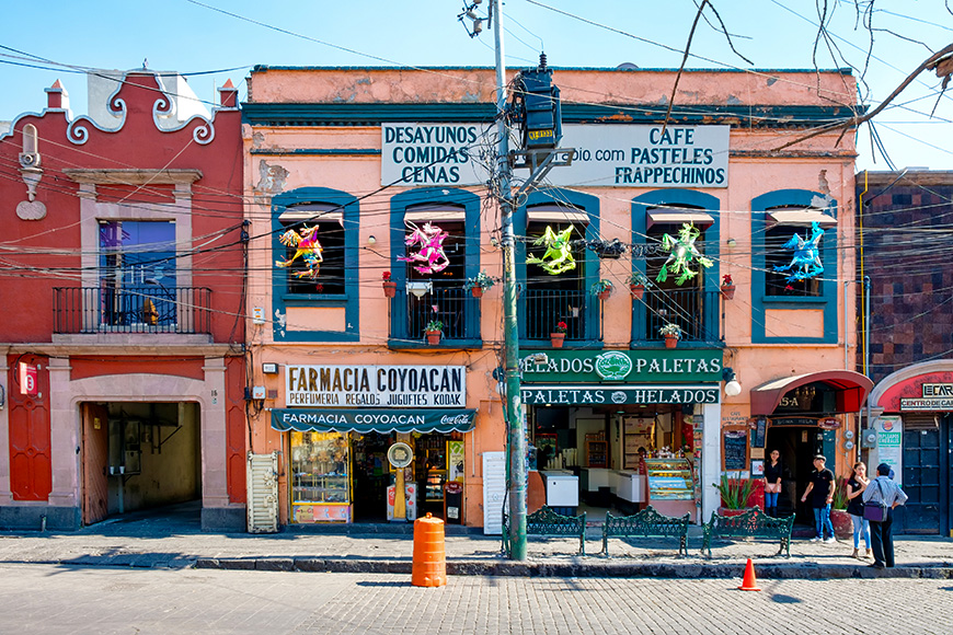 Local businesses at a colorful colonial building in Coyoacan, a historic neighborhhod in Mexico City K