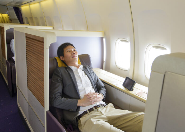 man in first class on airplane.