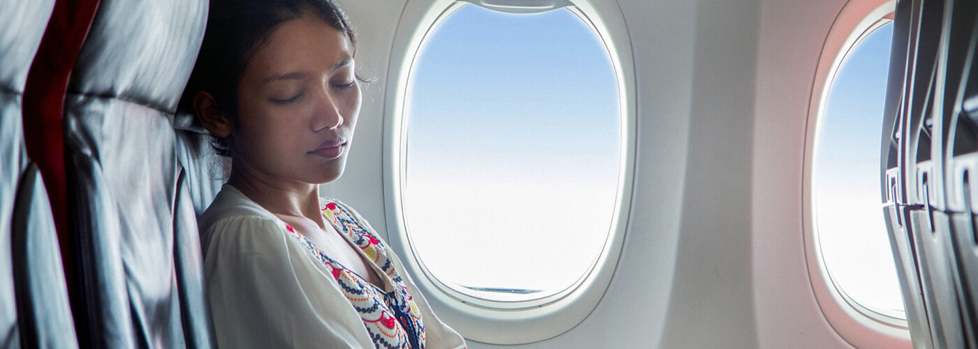 woman sleeping on plane.