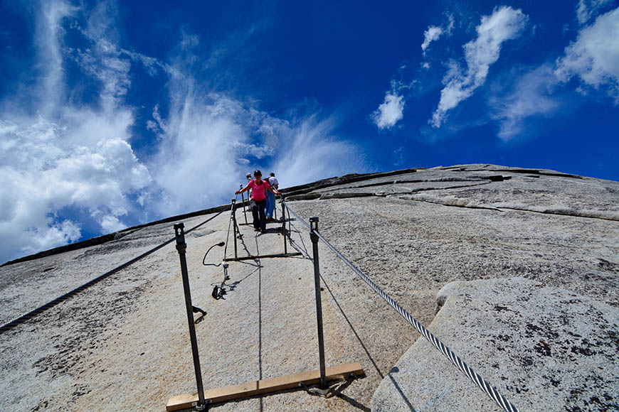 half dome yosemite hikers with cables.