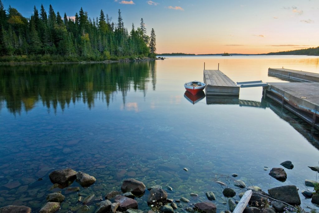 A small boat moored at a dock in Isle Royale National Park, Michigan