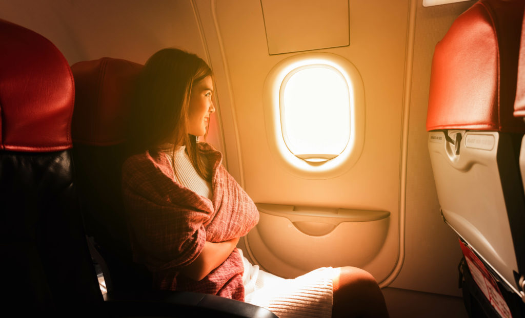 Woman sitting in a plane and looking out the window
