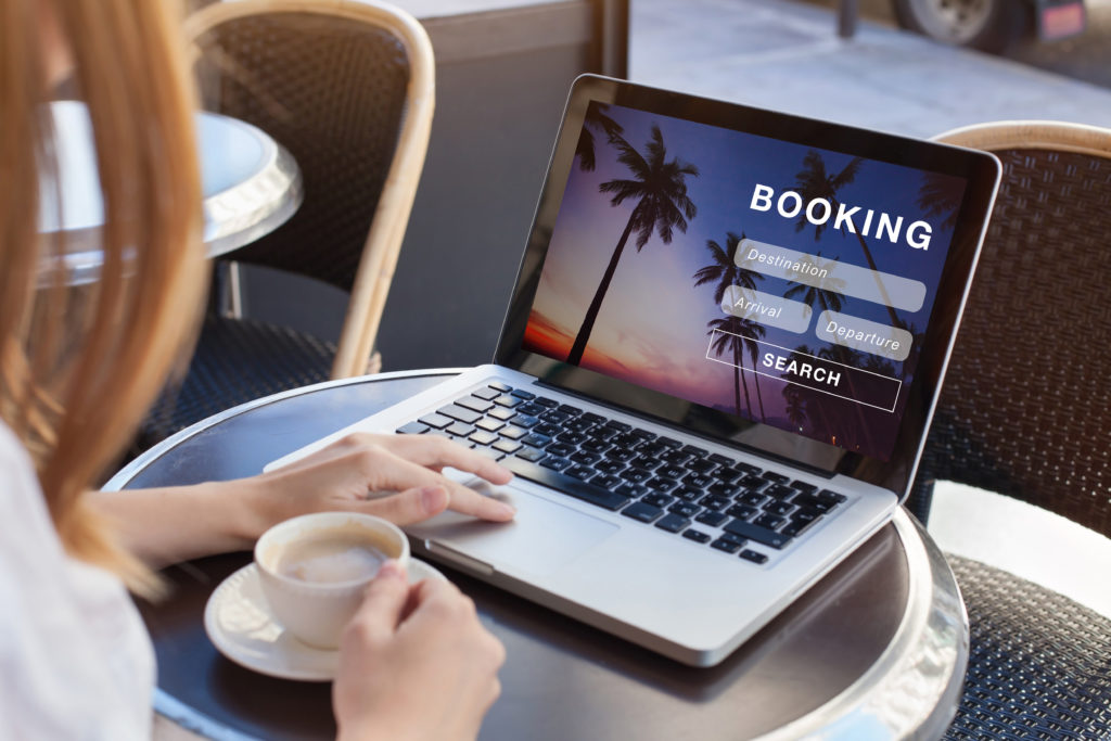 Woman drinking coffee and booking a flight