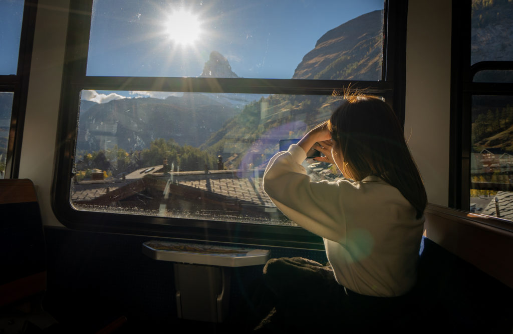 Woman taking photo out of train window