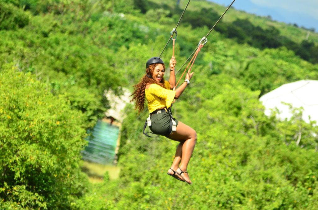 Woman ziplining in jungle