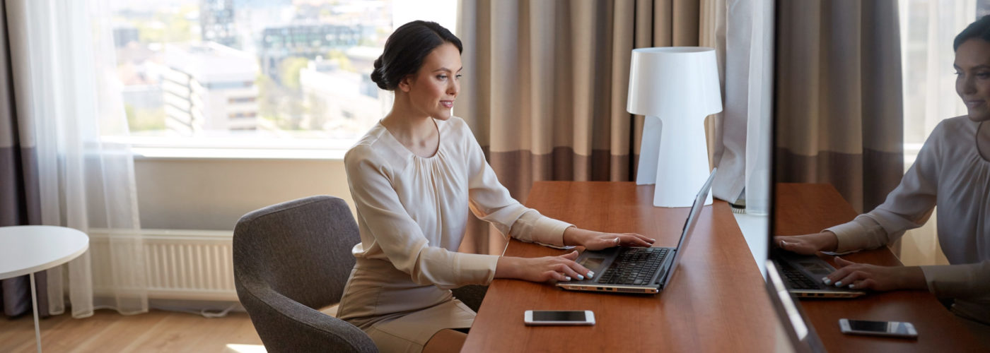 Woman working in hotel room