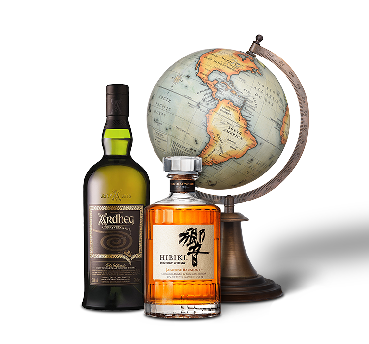 Two bottles of whiskey in front of a globe