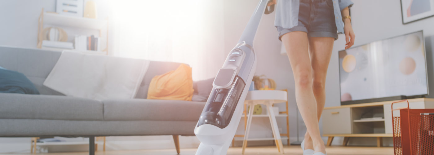 Woman vacuuming with a cordless vacuum