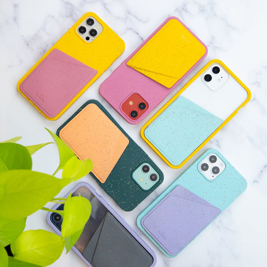Several colors of Pela phone case with attachable card holder on marble background
