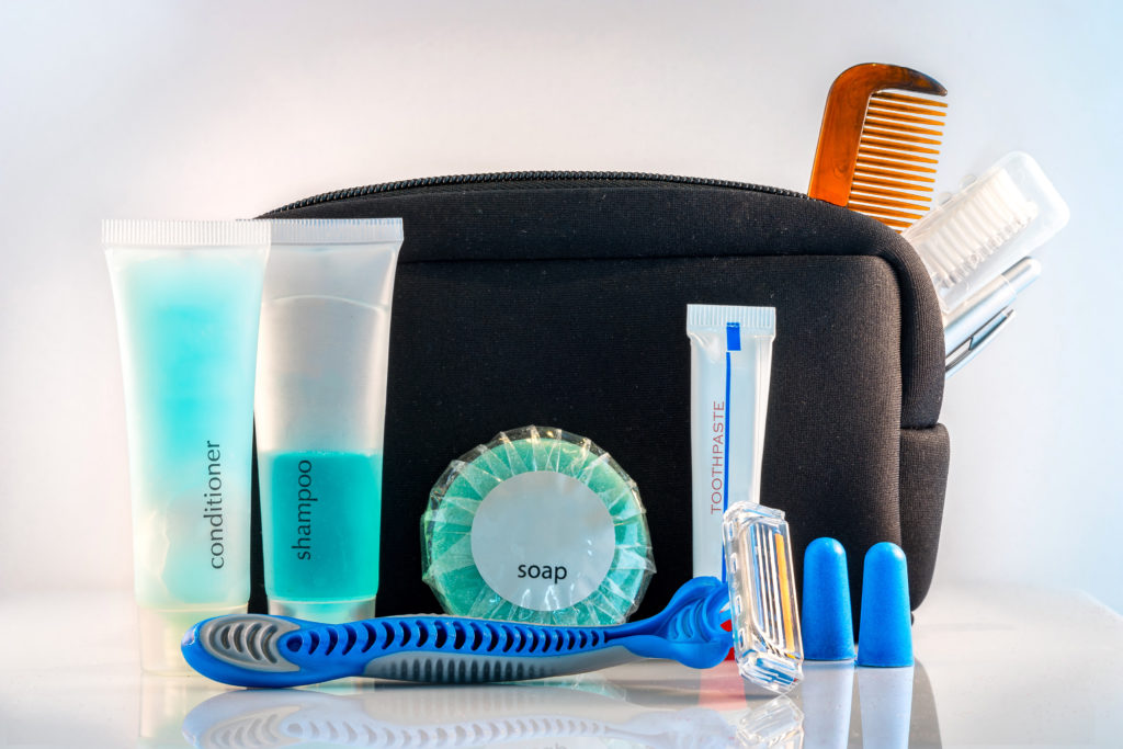 A travel toiletry kit on a white background