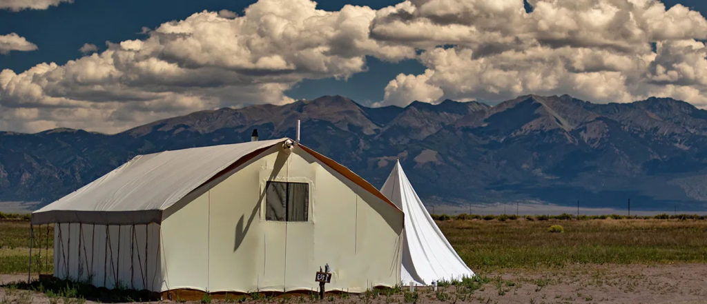 Tent at Rustic Rook Resort on a backdrop of tall mountains