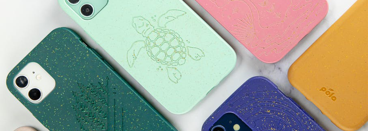 Several colors of Pela phone case on a white marble background