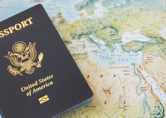 Passport on a world map backdrop